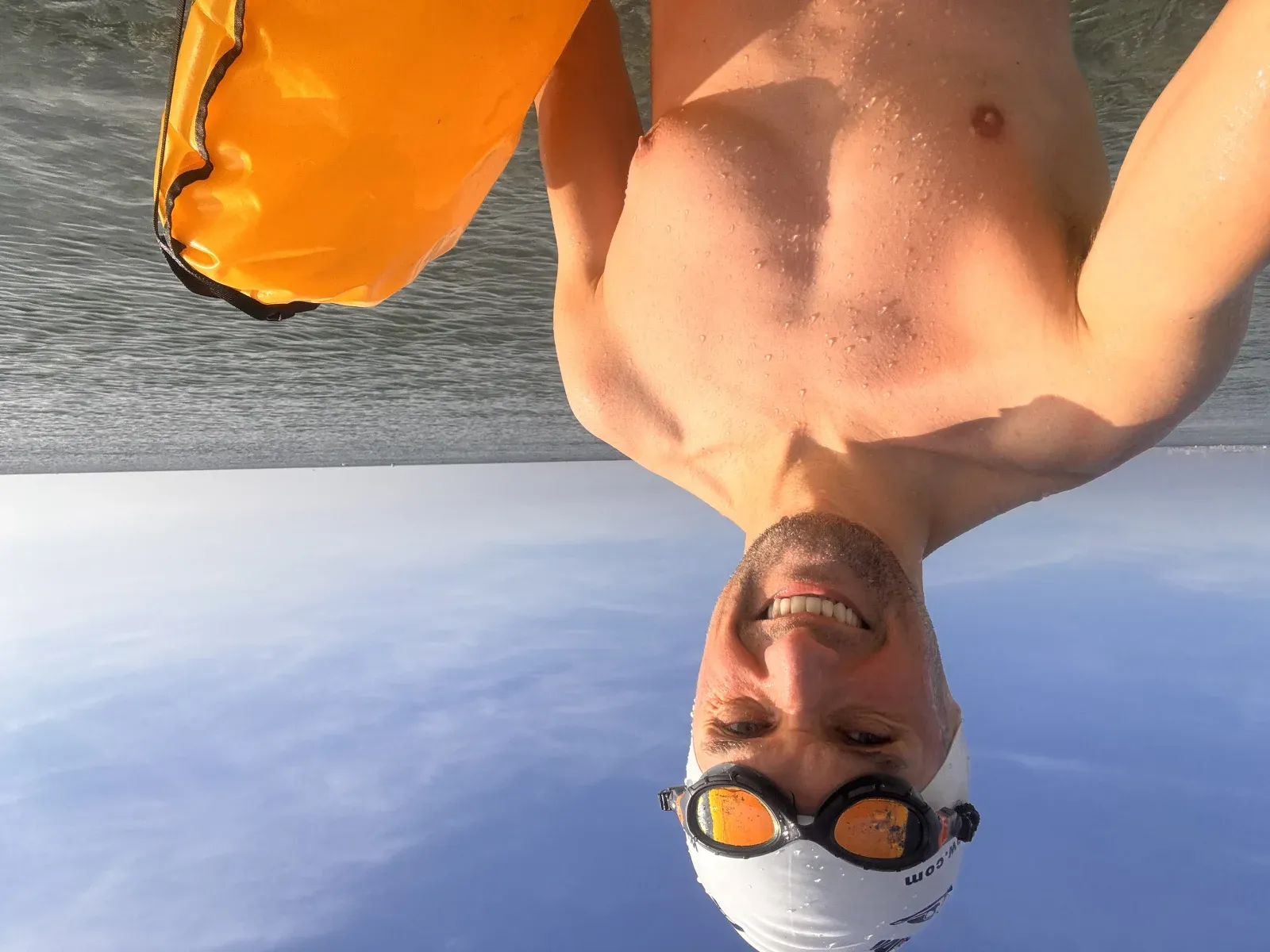 VimoSwim co-founder after an open-water swim by the sea, holding a tow float