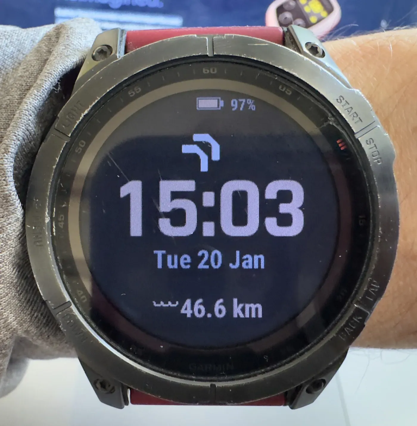 The swim distance widget on my watch face reading 46.6 km, with a Vimo tempo trainer on the desk behind it