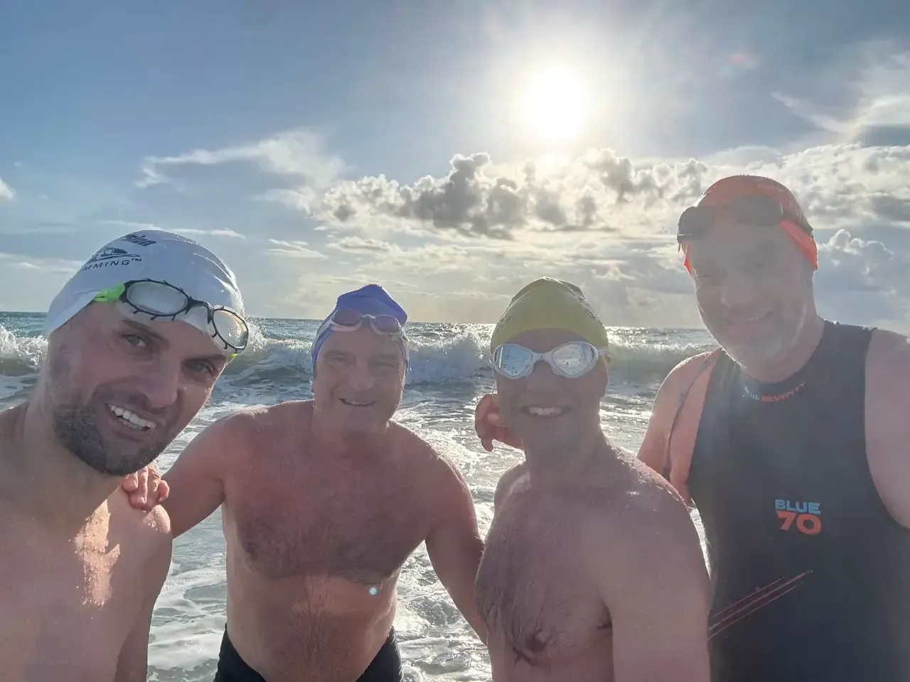 Four of us in the water after an evening sea session