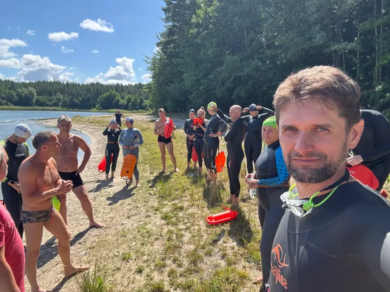 The group gathered on the shore before a session, tow floats ready
