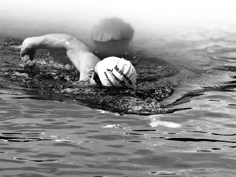A swimmer working on stroke technique in open water