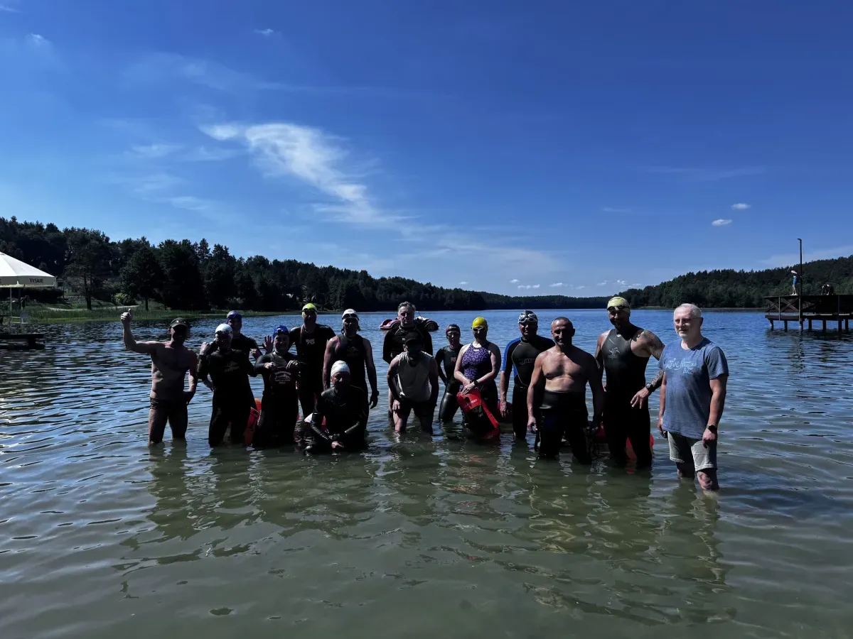 Camp participants gathered for a group photo in the water