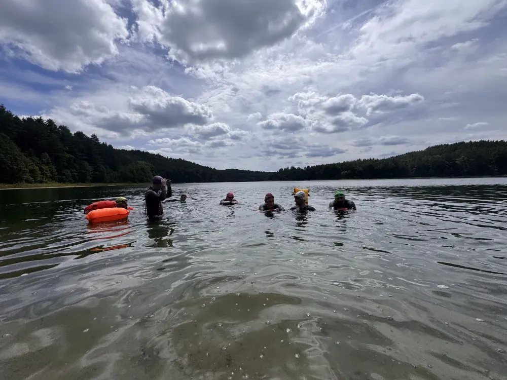 The group gathering in the water before a session