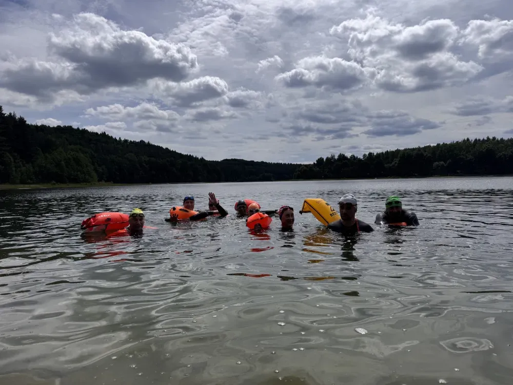 Swimmers waving from the water during a session
