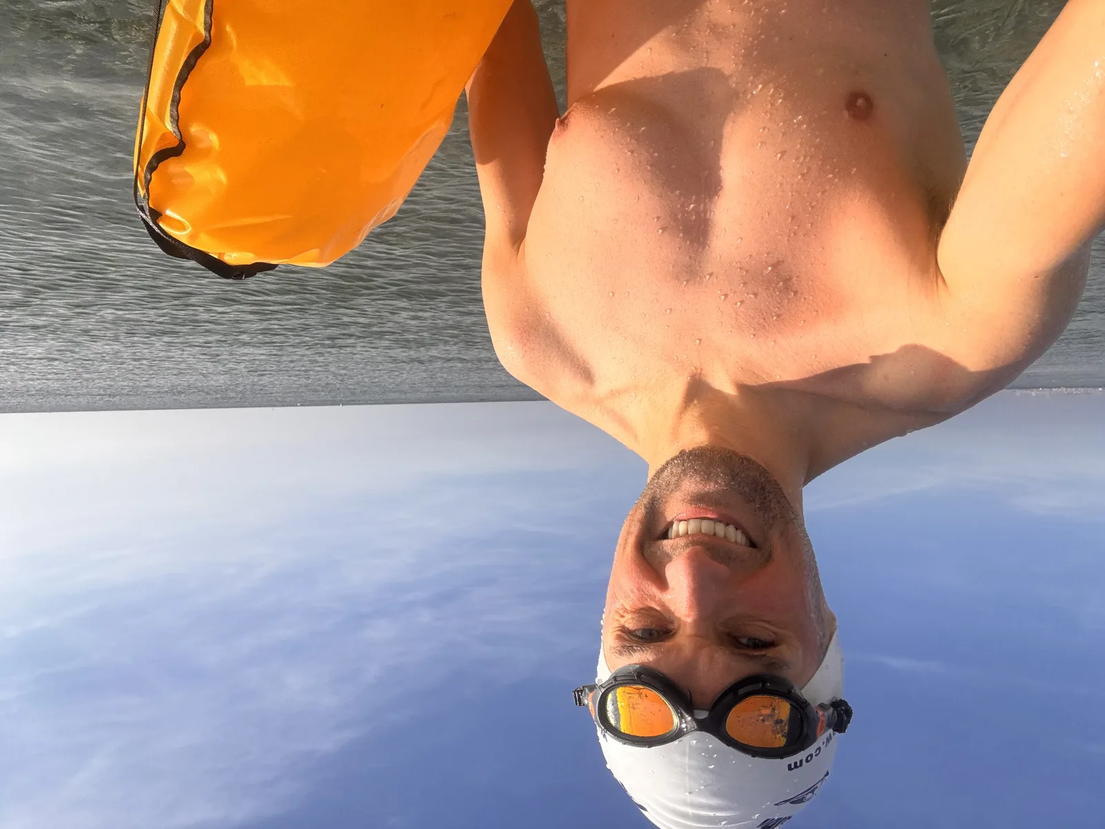 VimoSwim co-founder after an open-water swim by the sea, holding a tow float