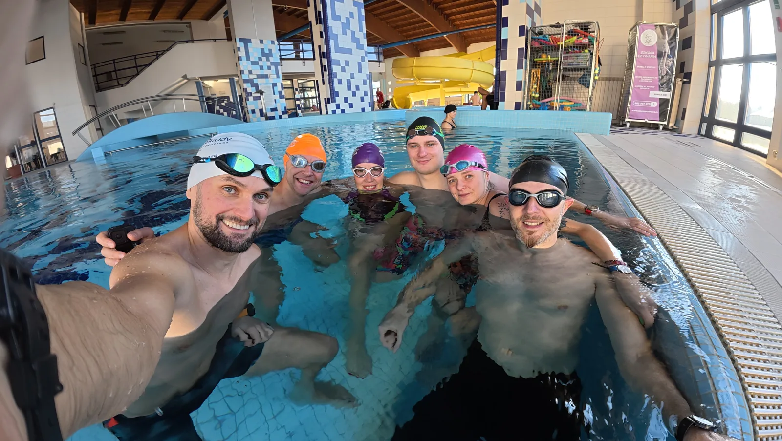 The VimoSwim team and swimmers together during a pool training session