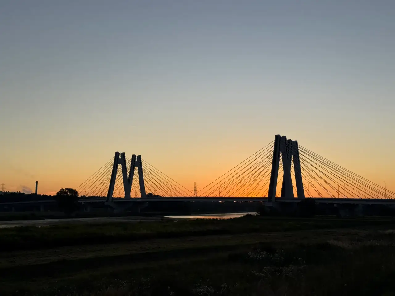 Cable-stayed bridge over the Vistula silhouetted at dawn