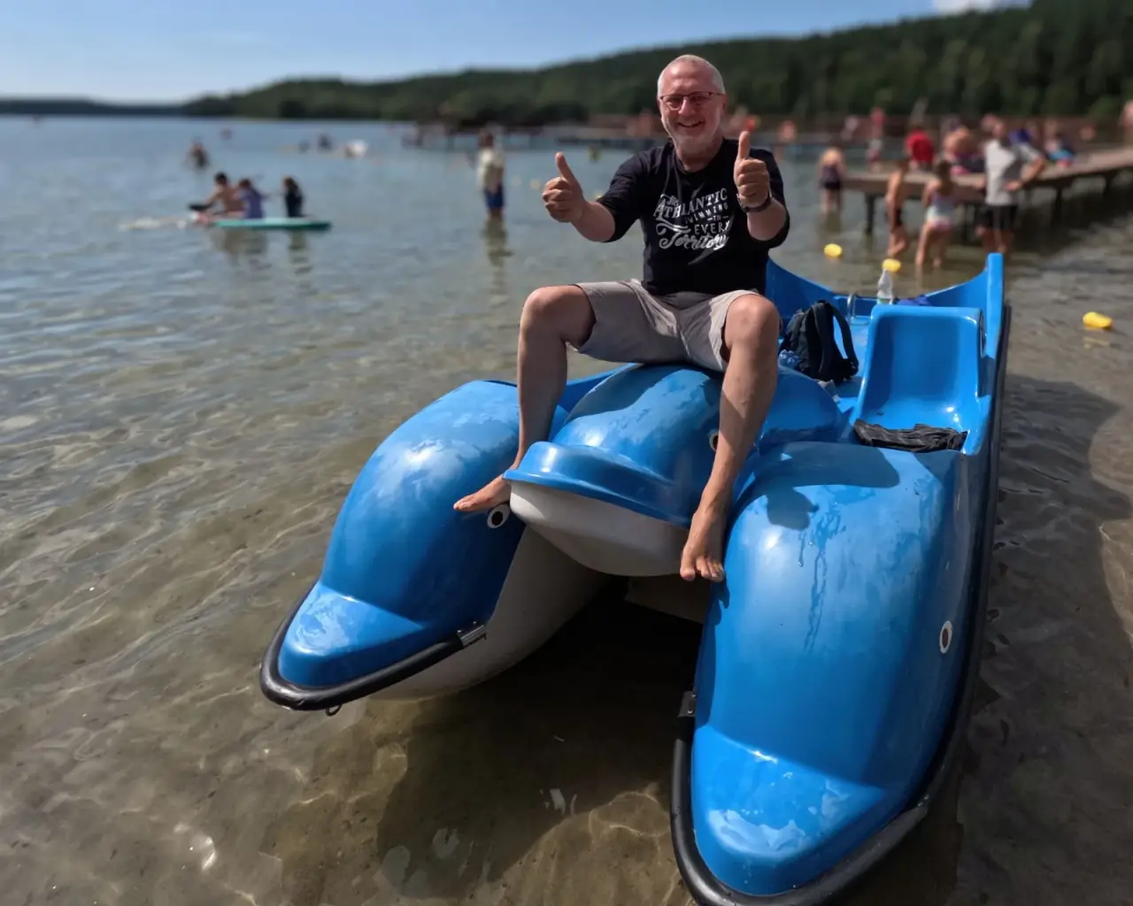 A camp participant on a pedal boat at the water's edge