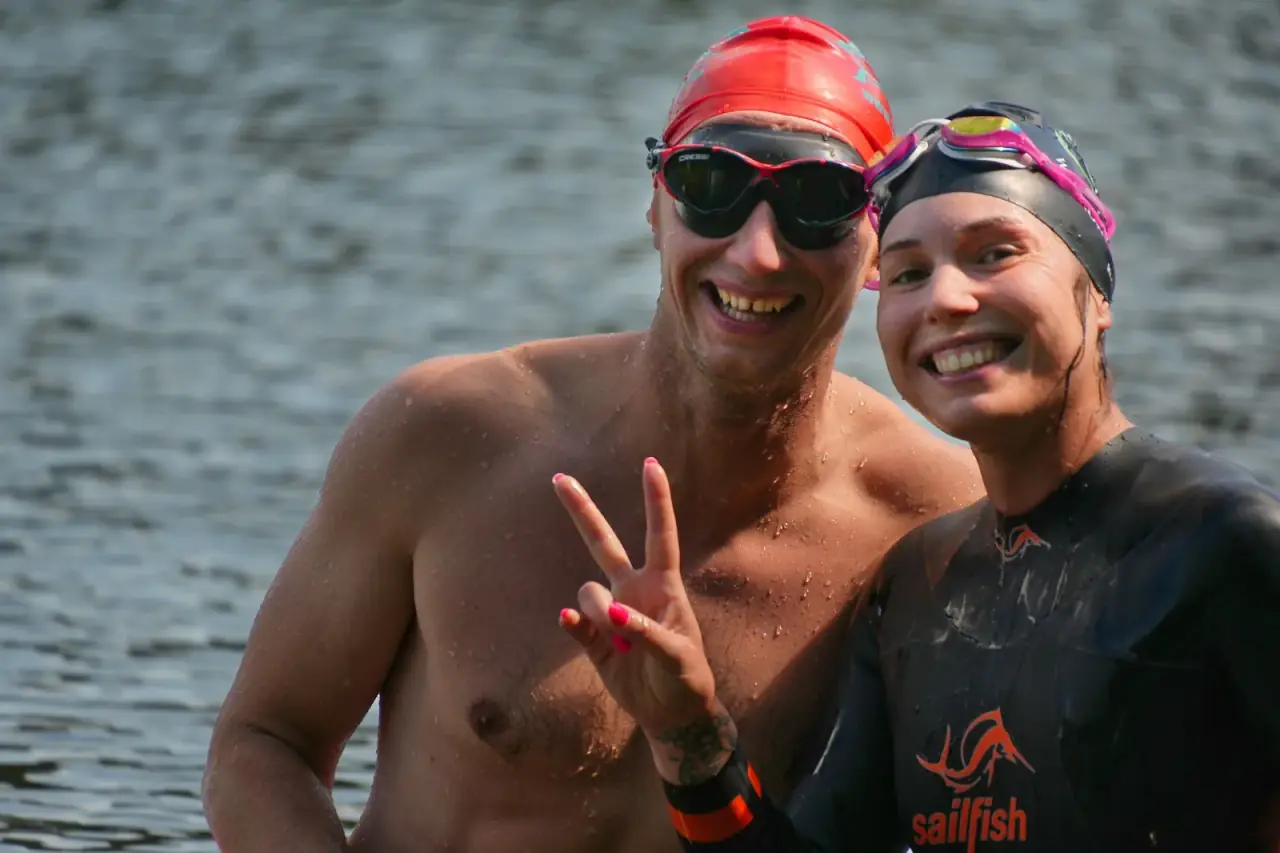 Two swimmers smiling in the water after a session