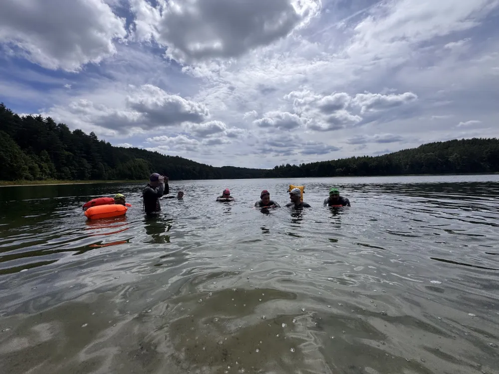 The group gathering in the water before a session