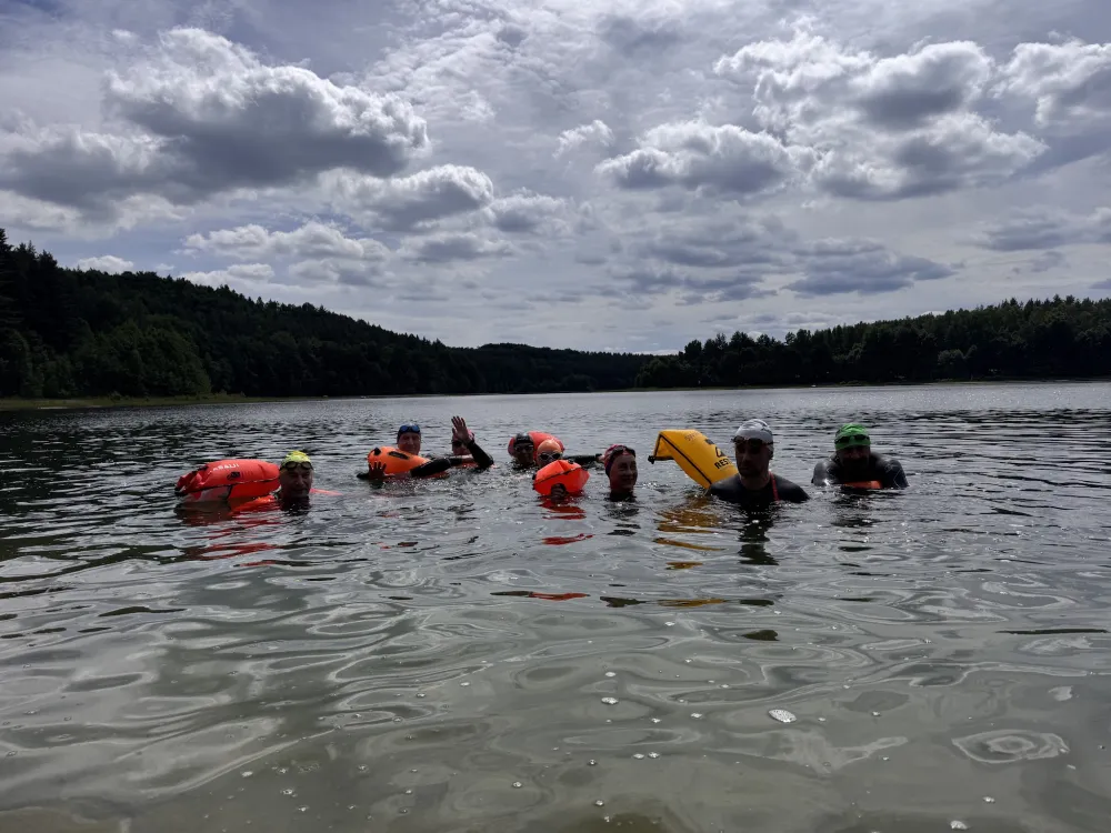 Swimmers waving from the water during a session