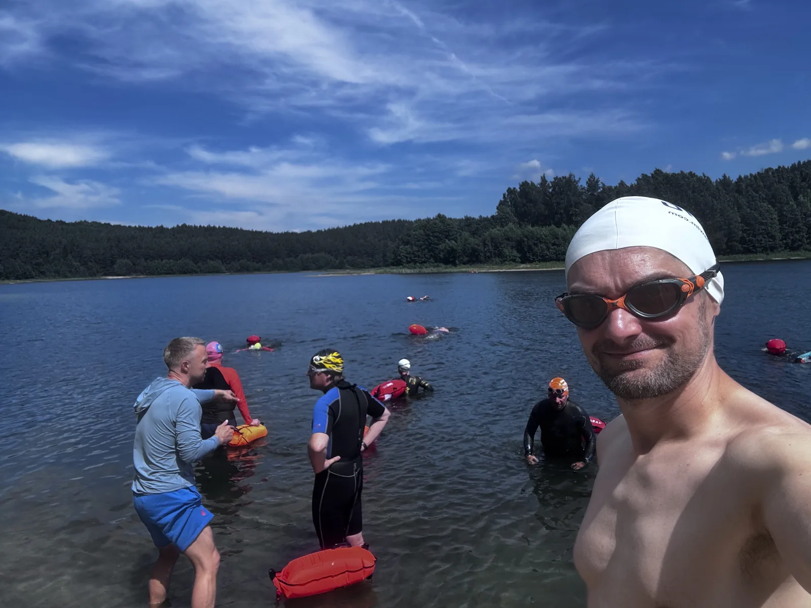 A swimmer takes a selfie at the lake as the group prepares for a session