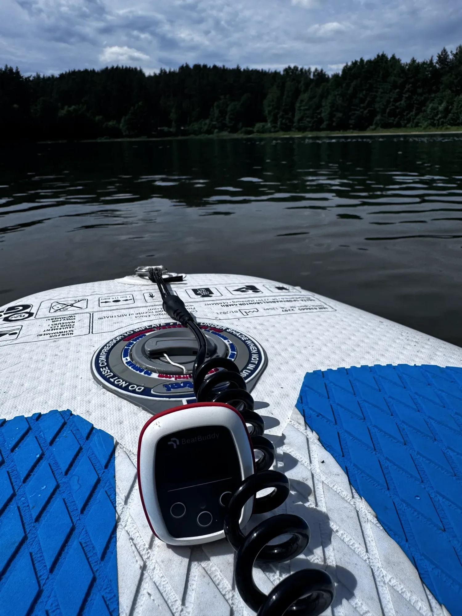 Vimo device on a paddle board leash on a calm lake