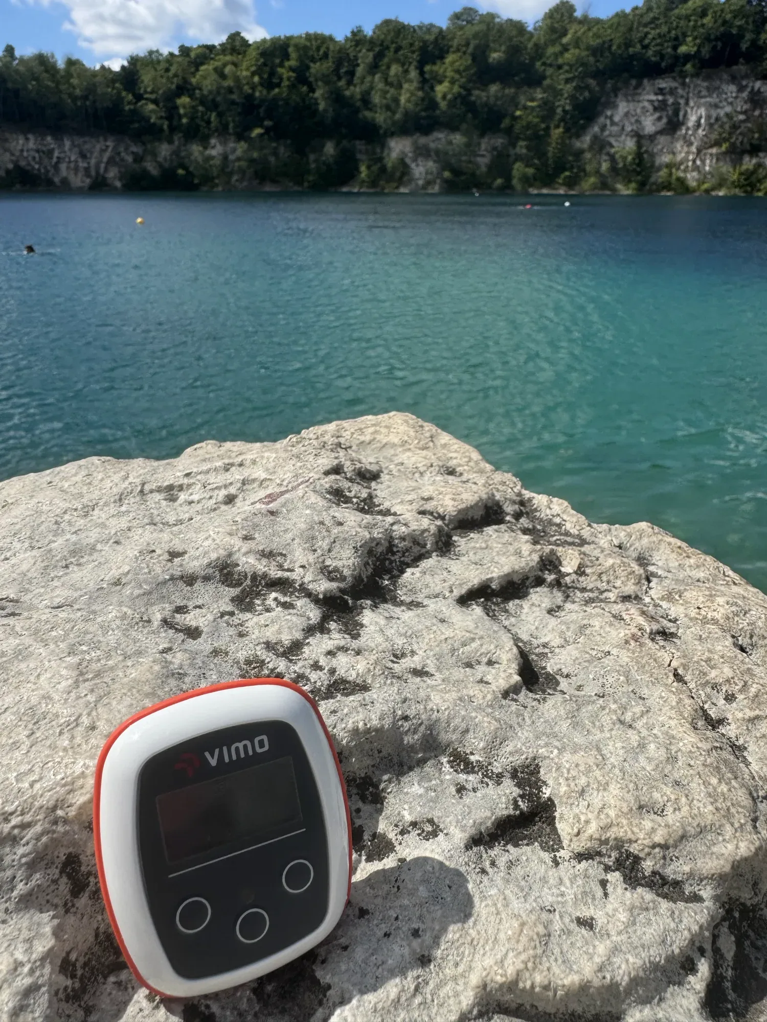 Vimo device on a rock above a turquoise quarry lake